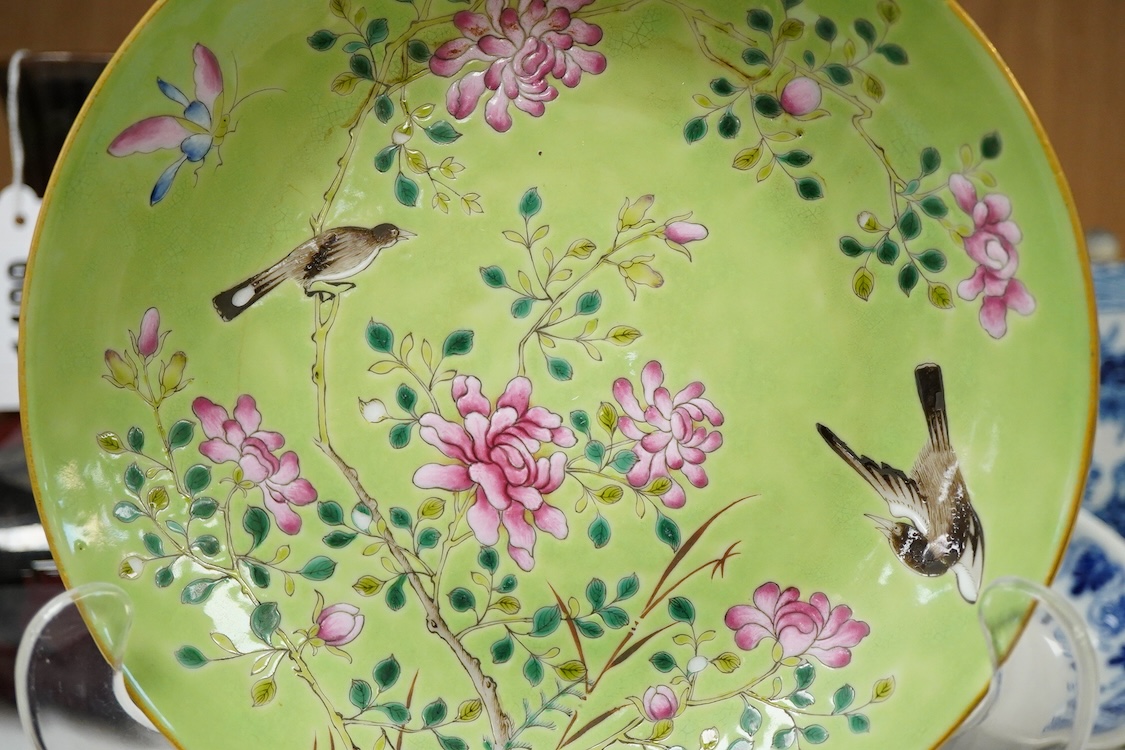 A Chinese famille rose and green ground dish decorated with birds amongst flowers, 17cm in diameter